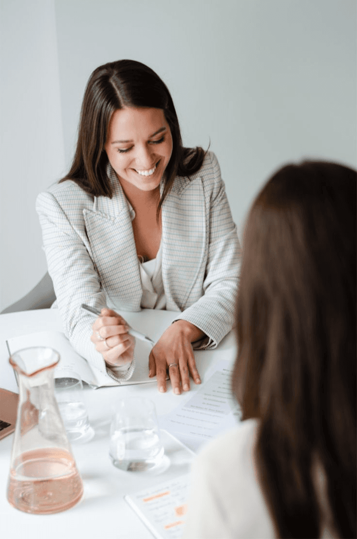 Consultant smiling while completing a client intake form