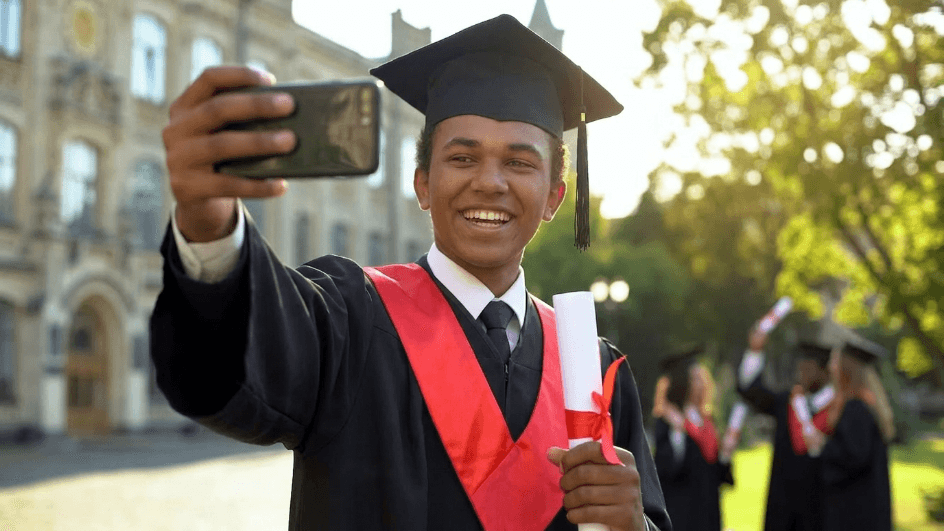 Graduate taking a selfie in a cap and gown