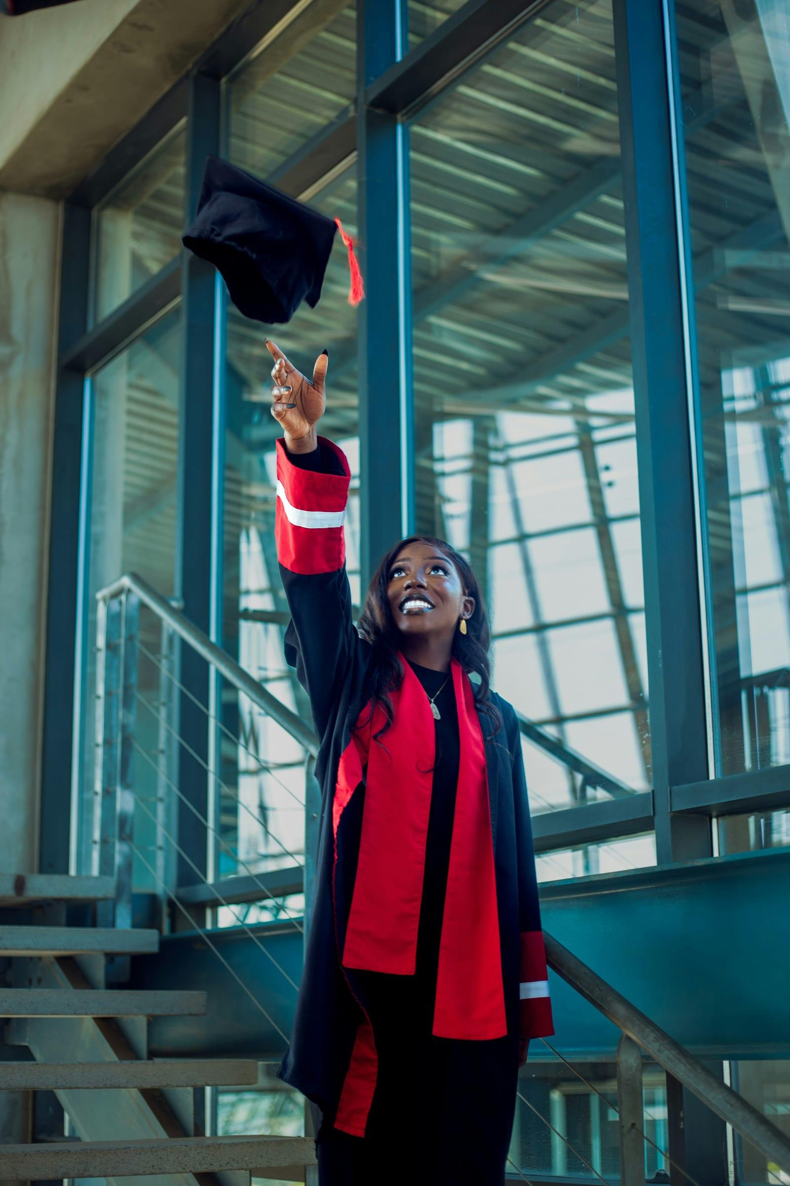 Graduate in a gown celebrating after studying abroad